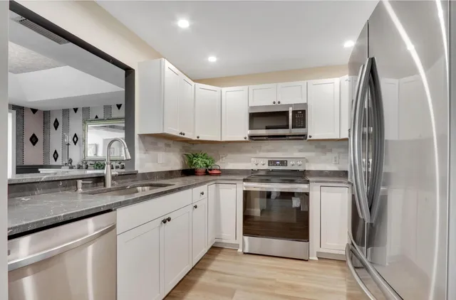 a living room with furniture city view and large windows