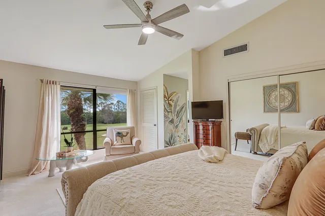 a bedroom with a large bed and a chandelier