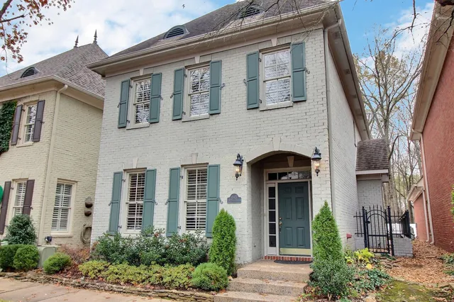 front view of a brick house with a large windows