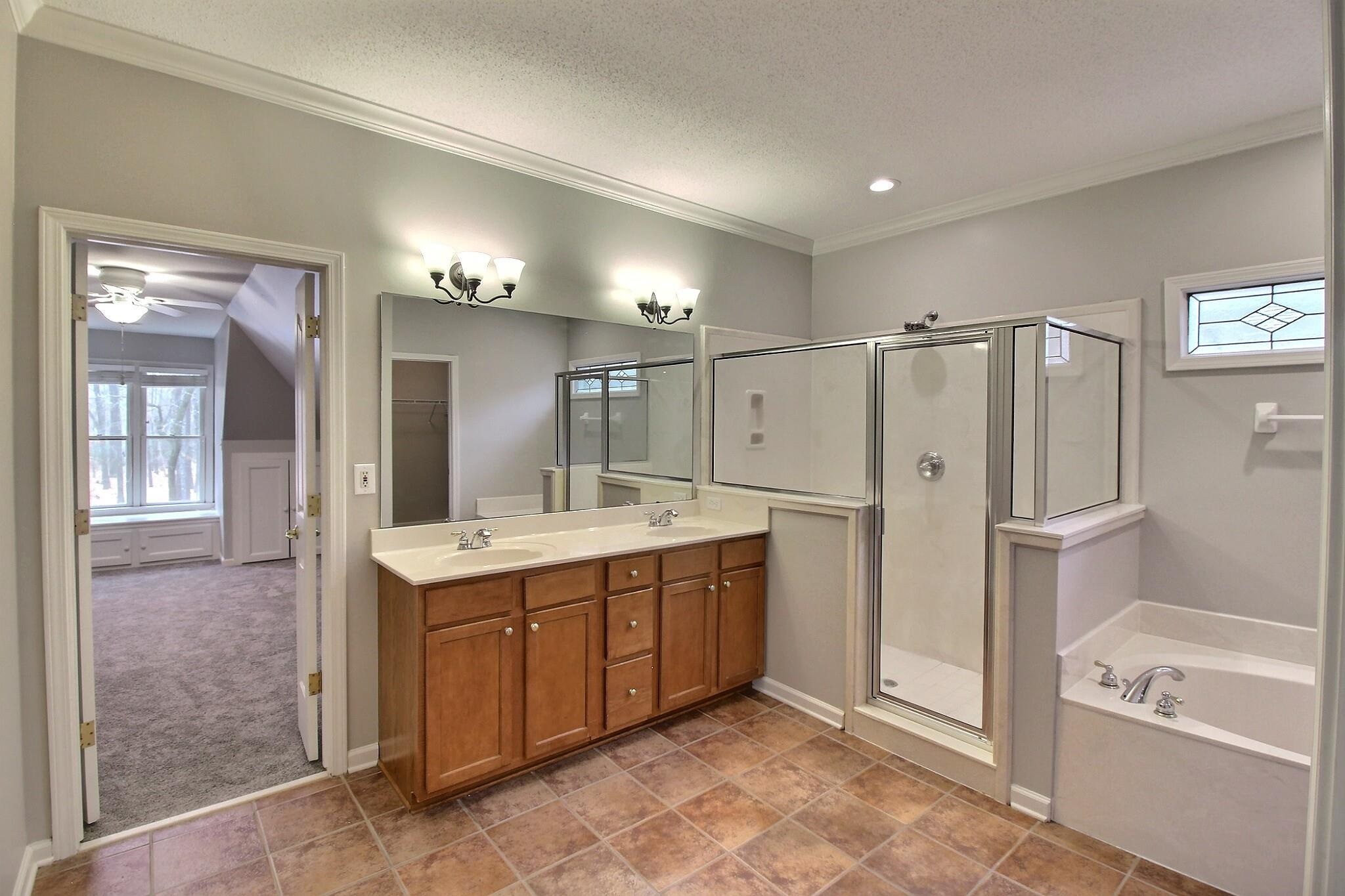 845 McFerrin Lane Collierville, TN 38017 - Photo 13 of 27 a bathroom with a tub a sink shower and mirror