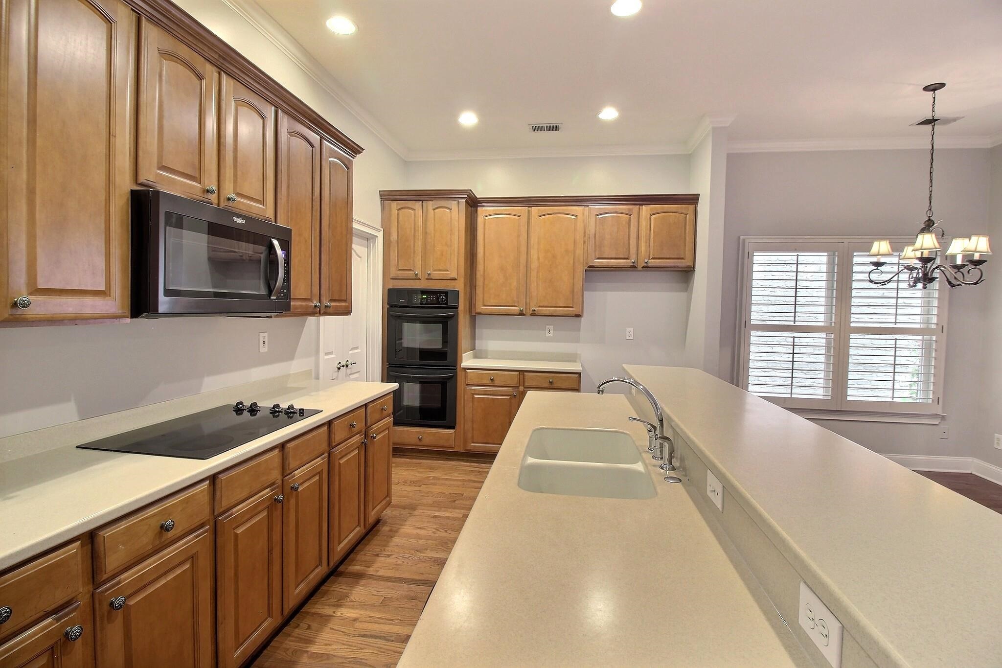 845 McFerrin Lane Collierville, TN 38017 - Photo 6 of 27 a large kitchen with stainless steel appliances granite countertop a sink and cabinets