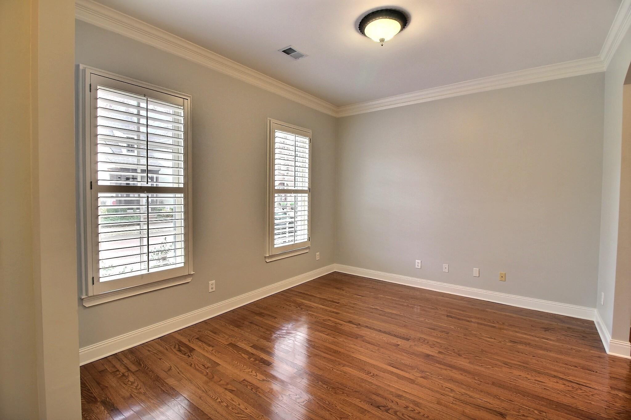 845 McFerrin Lane Collierville, TN 38017 - Photo 8 of 27 a view of an empty room with wooden floor and a window
