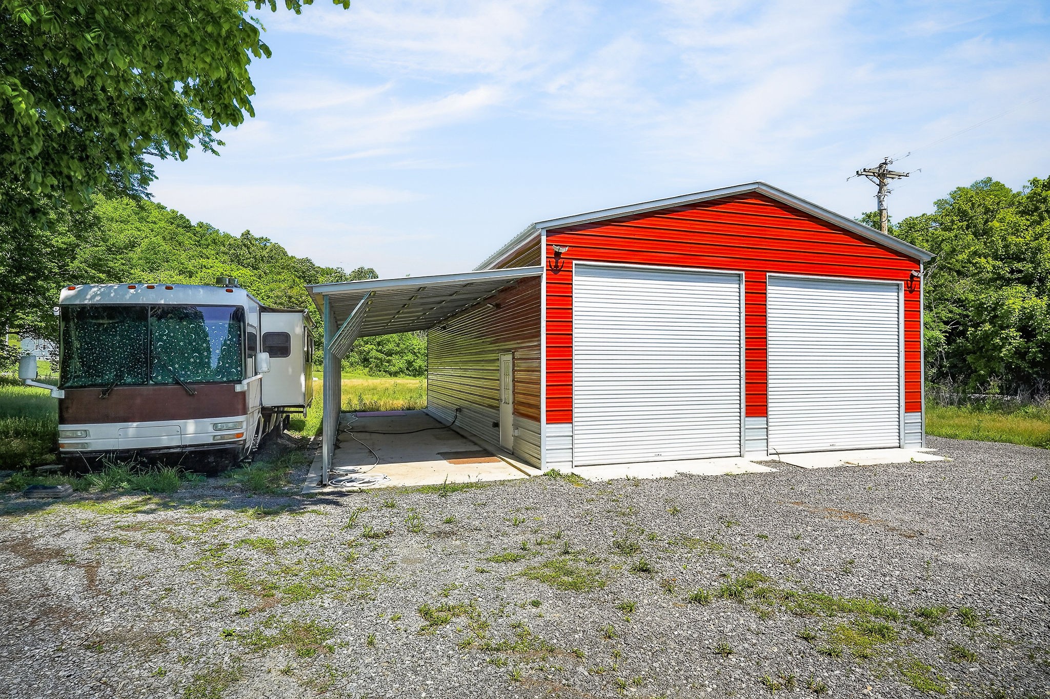16130 Buffalo Valley Road Silver Point, TN 38582 - Photo 16 of 47 a view of a house with a backyard and a garage