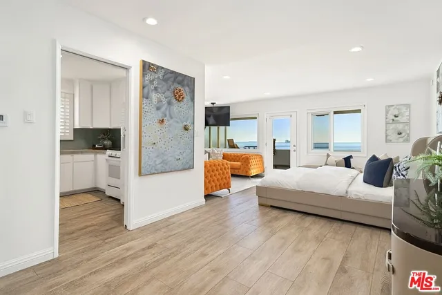 a bedroom with furniture and a large mirror