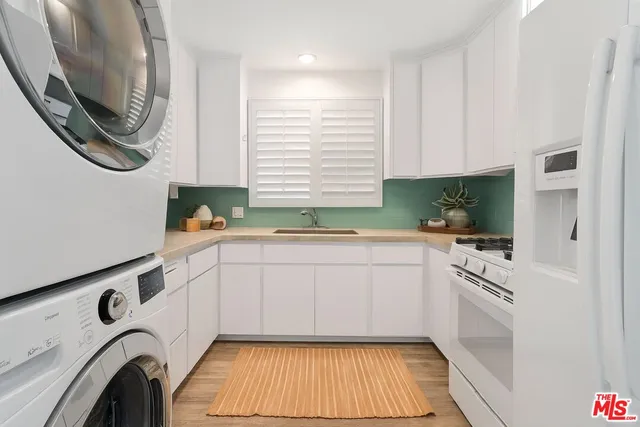 a kitchen with a white cabinets and a stove