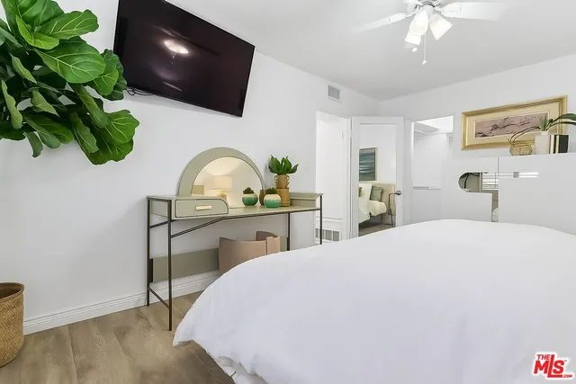 a bedroom with a bed and a flat screen tv