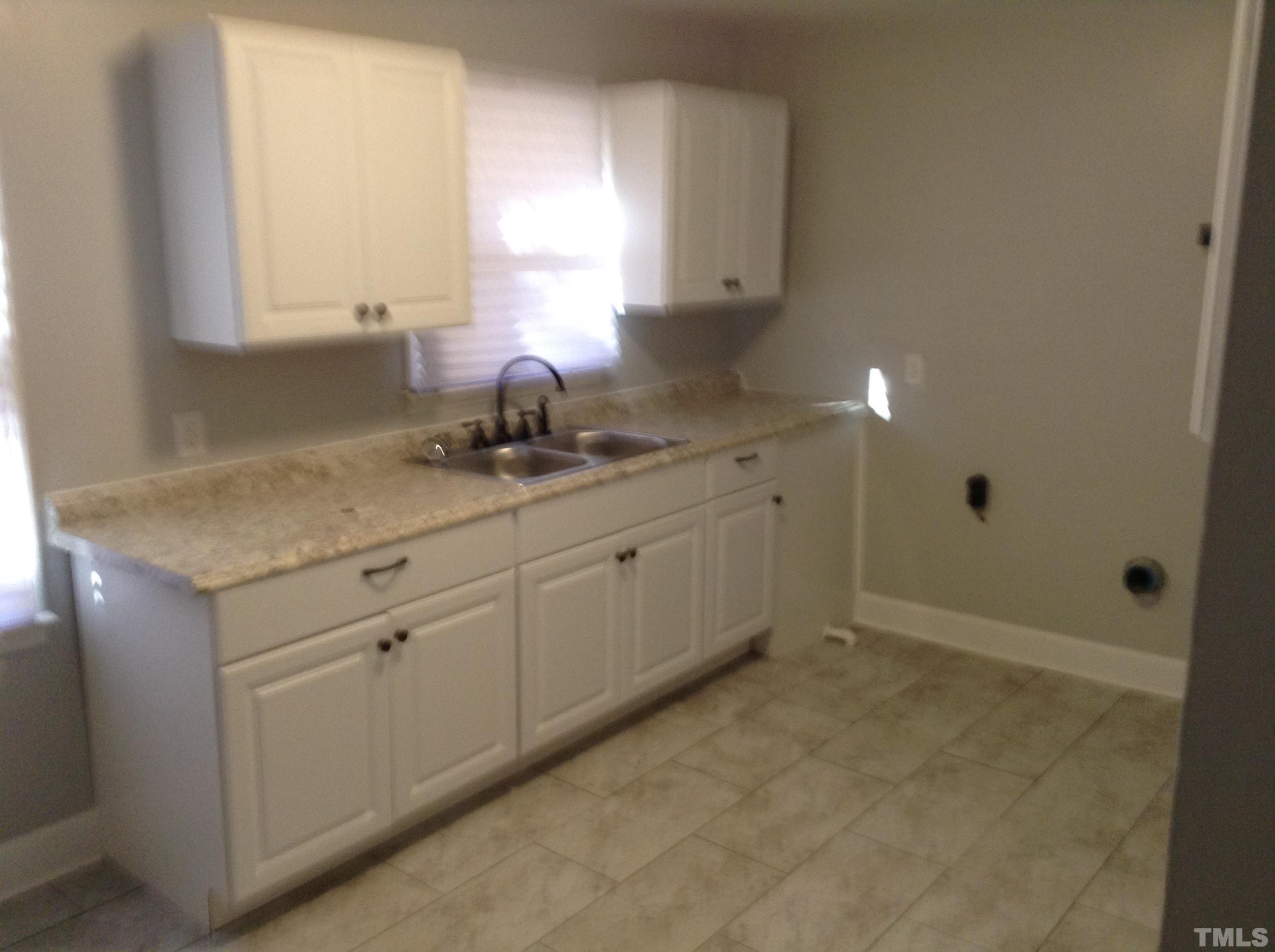 3901 Rock Quarry Road Raleigh, NC 27610 - Photo 6 of 10 a kitchen with a sink and cabinets
