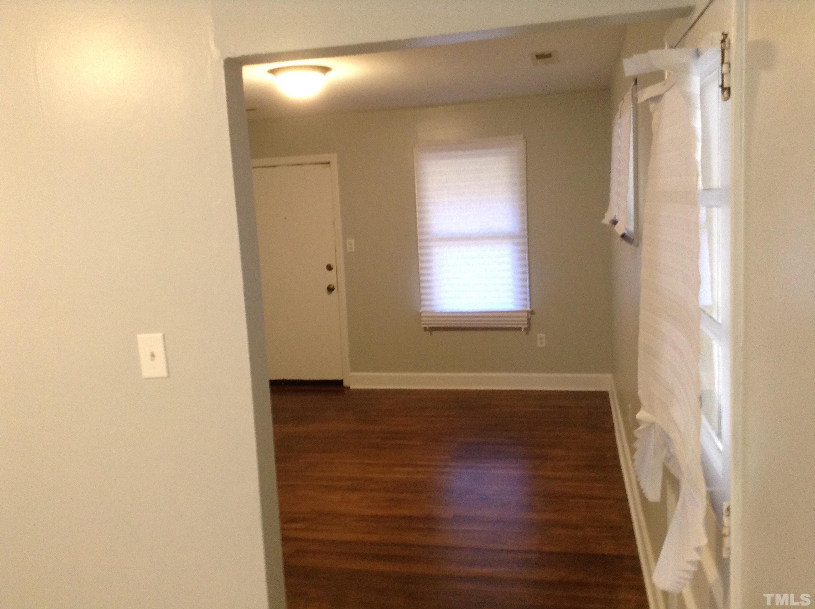 3901 Rock Quarry Road Raleigh, NC 27610 - Photo 8 of 10 a view of an empty room with wooden floor and a window