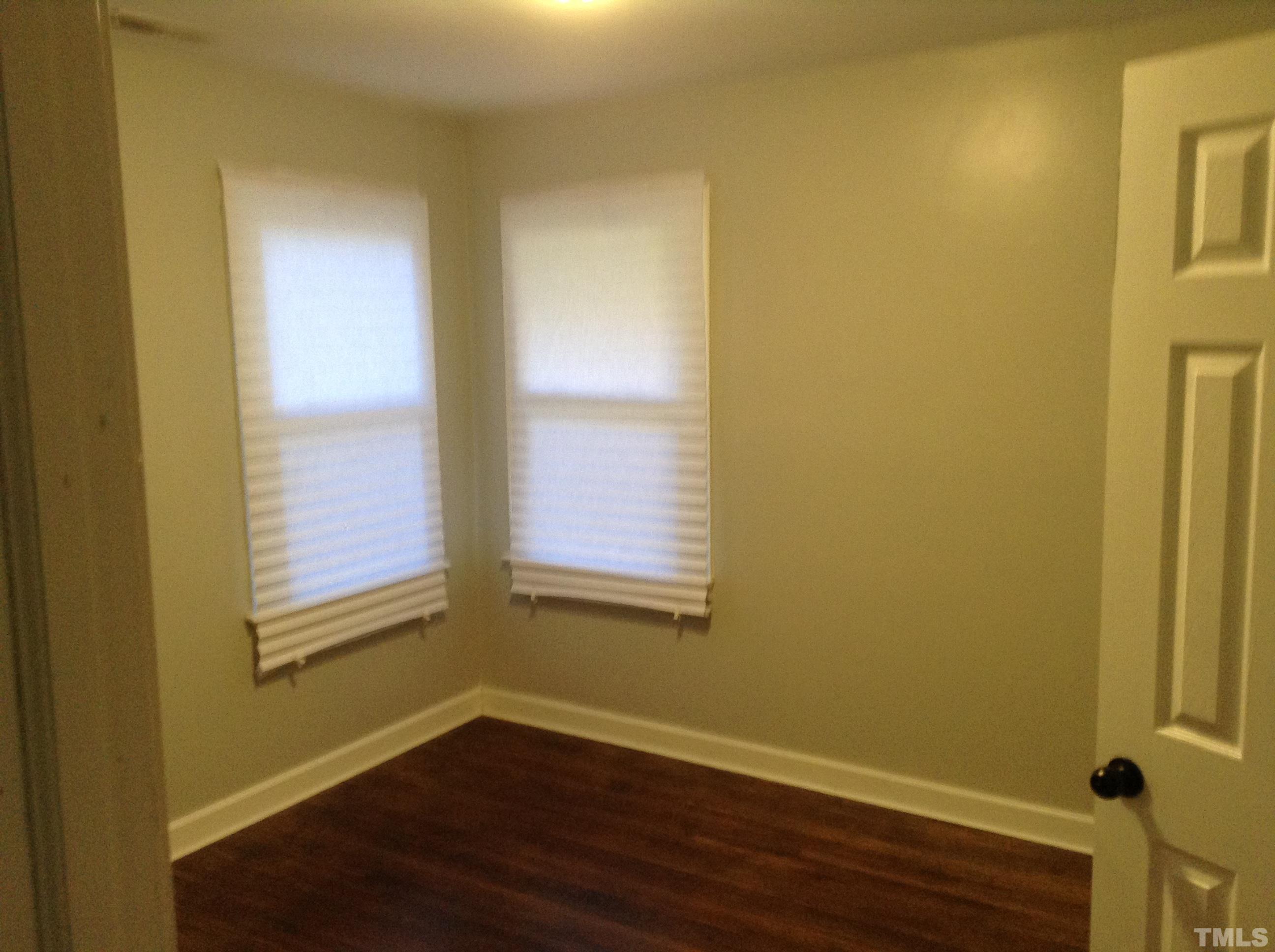 3901 Rock Quarry Road Raleigh, NC 27610 - Photo 9 of 10 a view of an empty room with wooden floor and a window