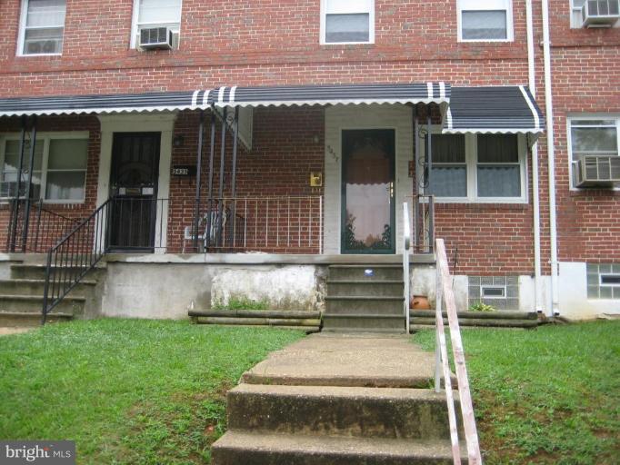 5437 Channing Road Baltimore, MD 21229 - Photo 1 of 25 a front view of a house with a yard