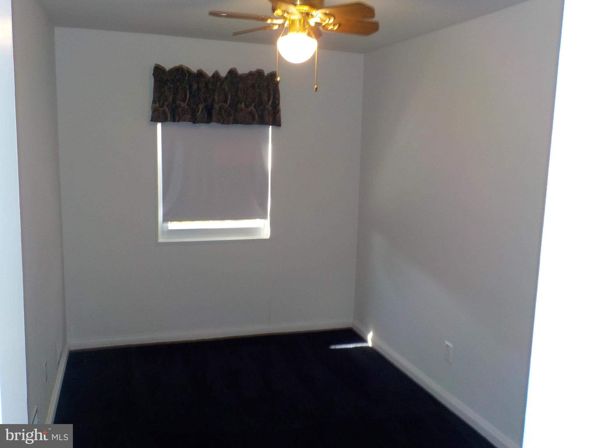 5437 Channing Road Baltimore, MD 21229 - Photo 11 of 25 a view of a small space with wooden floor and a window
