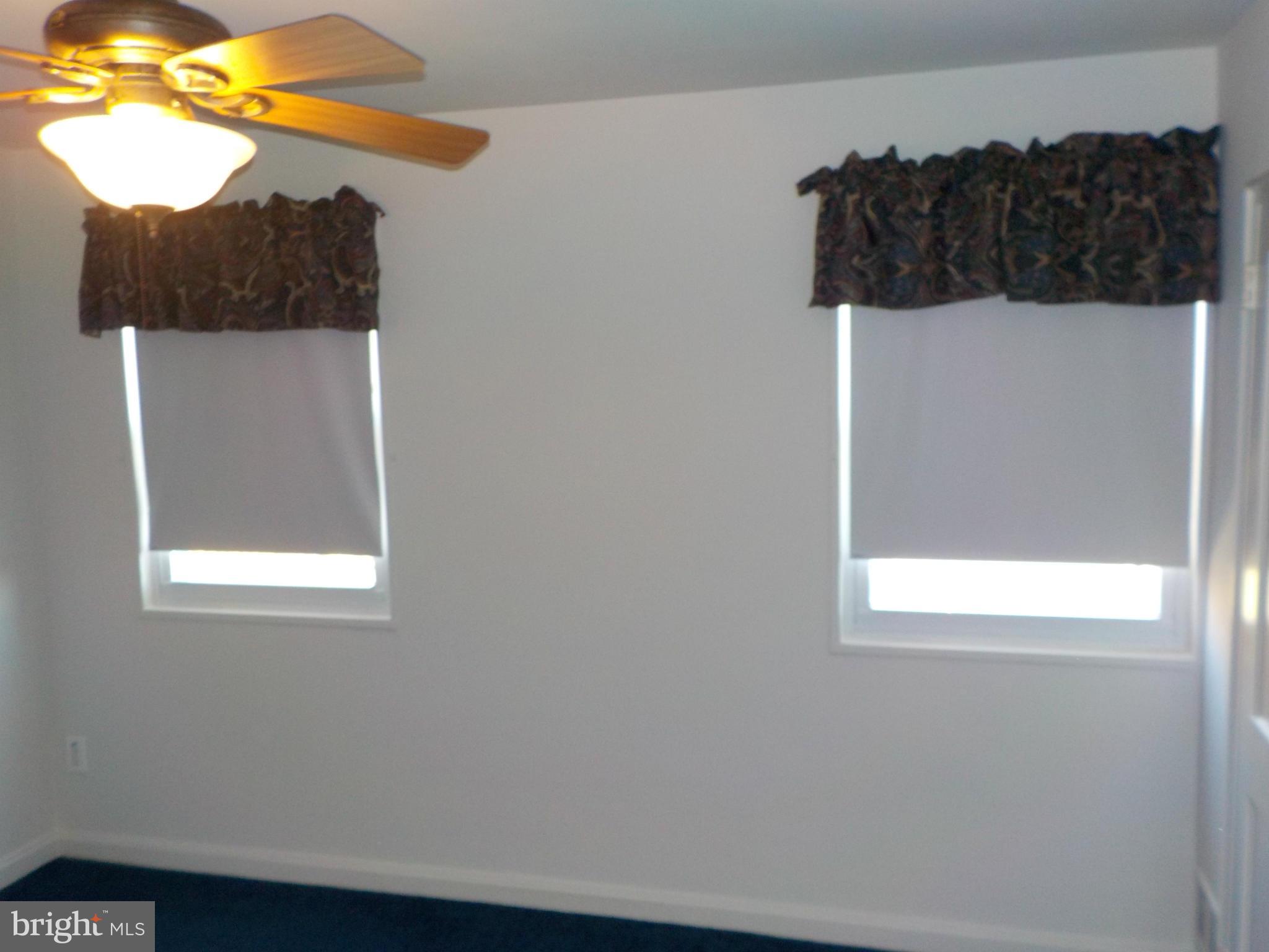 5437 Channing Road Baltimore, MD 21229 - Photo 14 of 25 a bathroom with a window and a shower