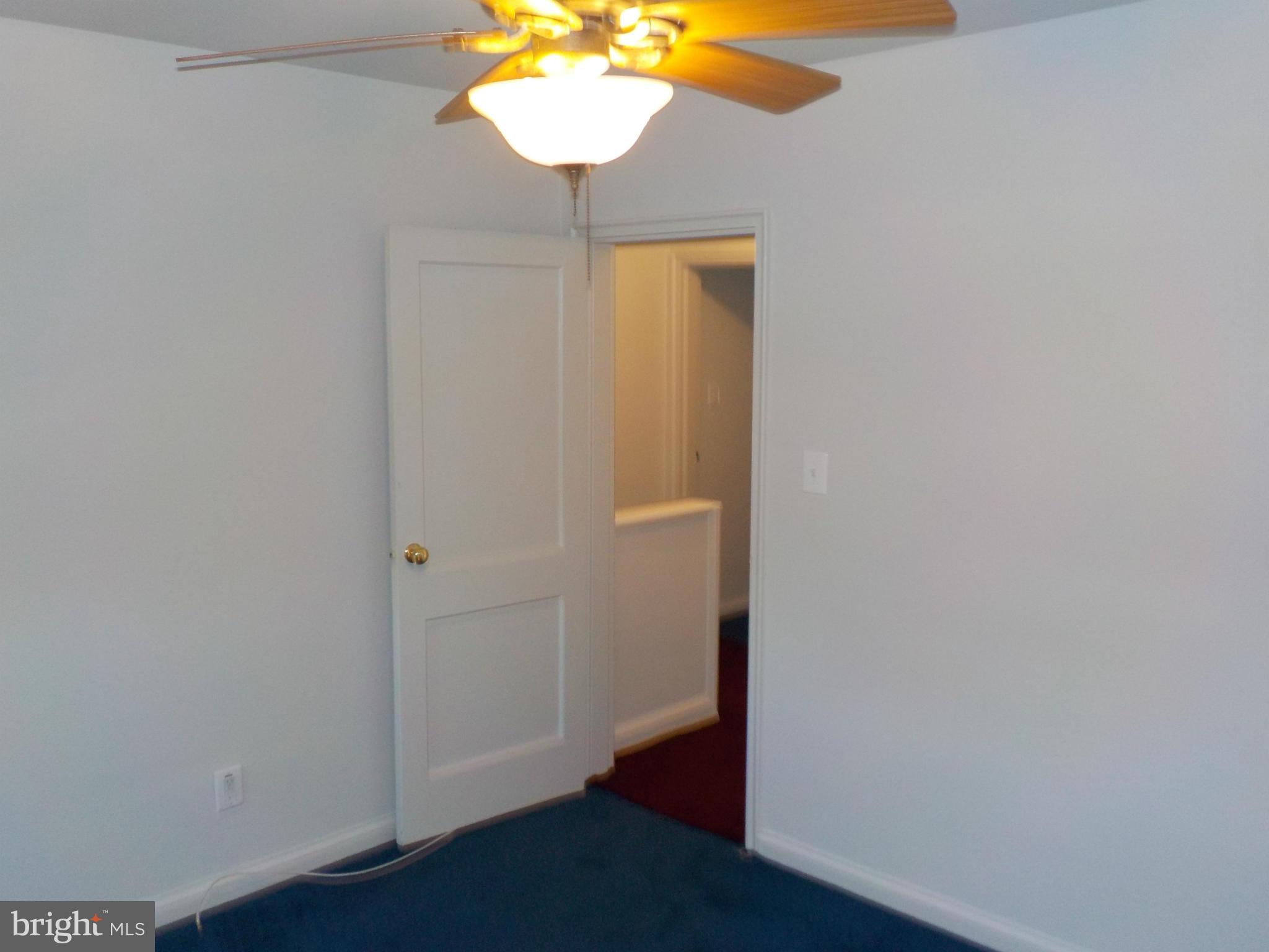 5437 Channing Road Baltimore, MD 21229 - Photo 16 of 25 an empty room with wooden floor