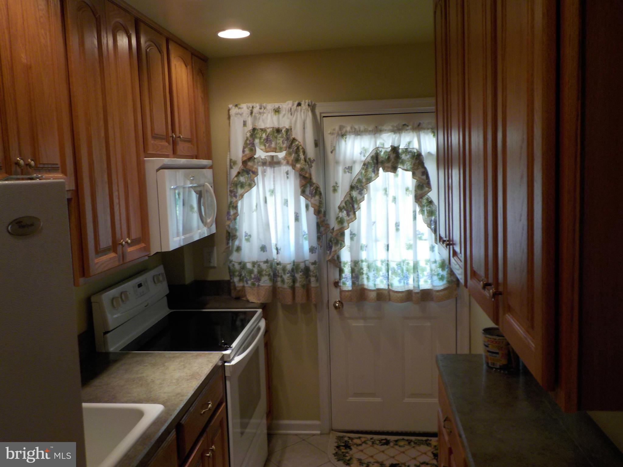 5437 Channing Road Baltimore, MD 21229 - Photo 7 of 25 a kitchen with a stove and a refrigerator
