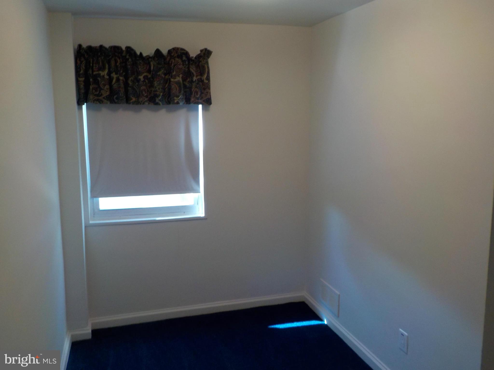 5437 Channing Road Baltimore, MD 21229 - Photo 10 of 25 a view of a small space with wooden floor and a window