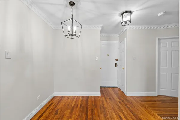 a view of a room with wooden floor and ceiling fan