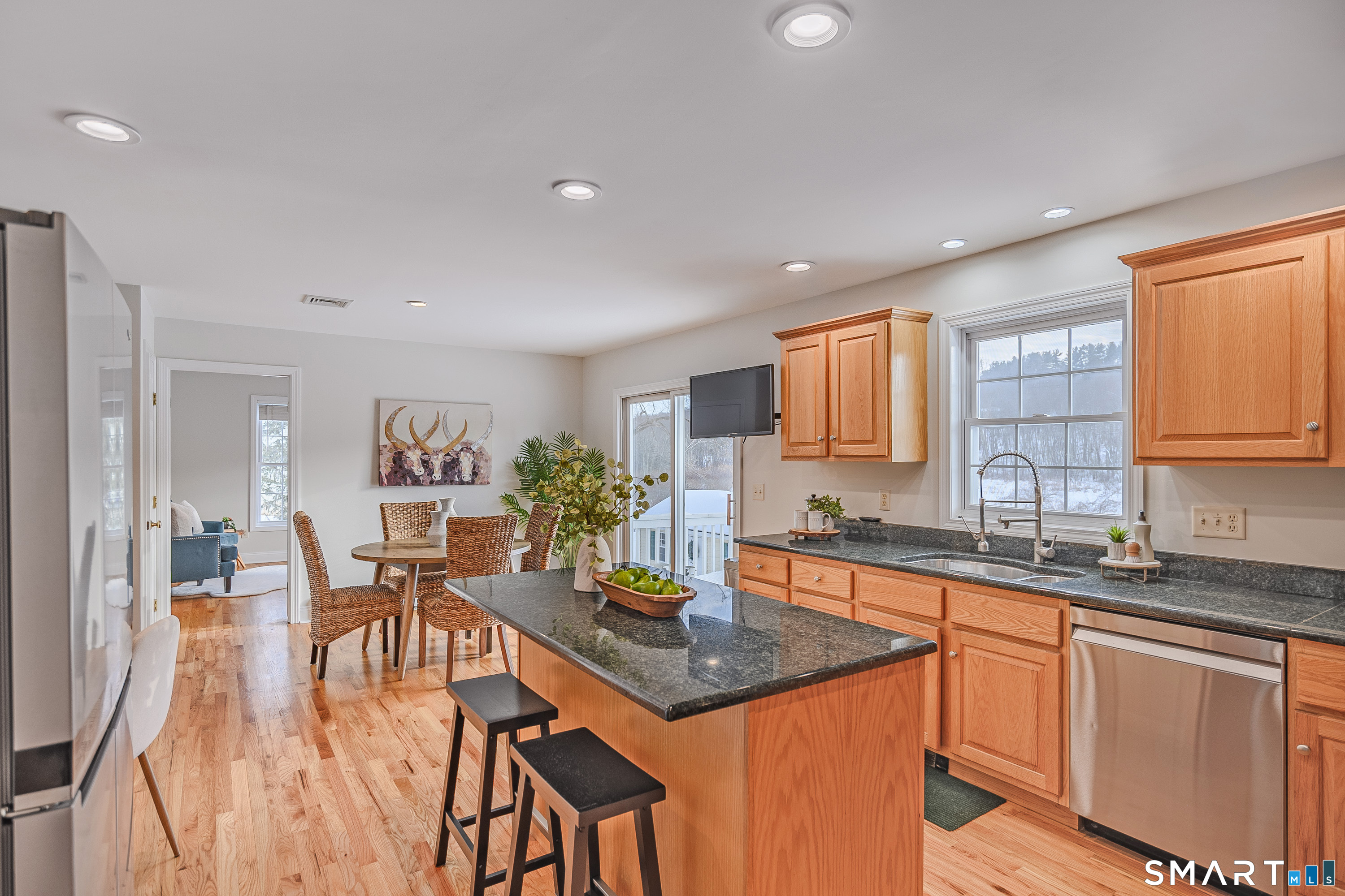 73 Dodgingtown Road Newtown, CT 06470 - Photo 21 of 39 a kitchen with a stove a sink a dining table and chairs