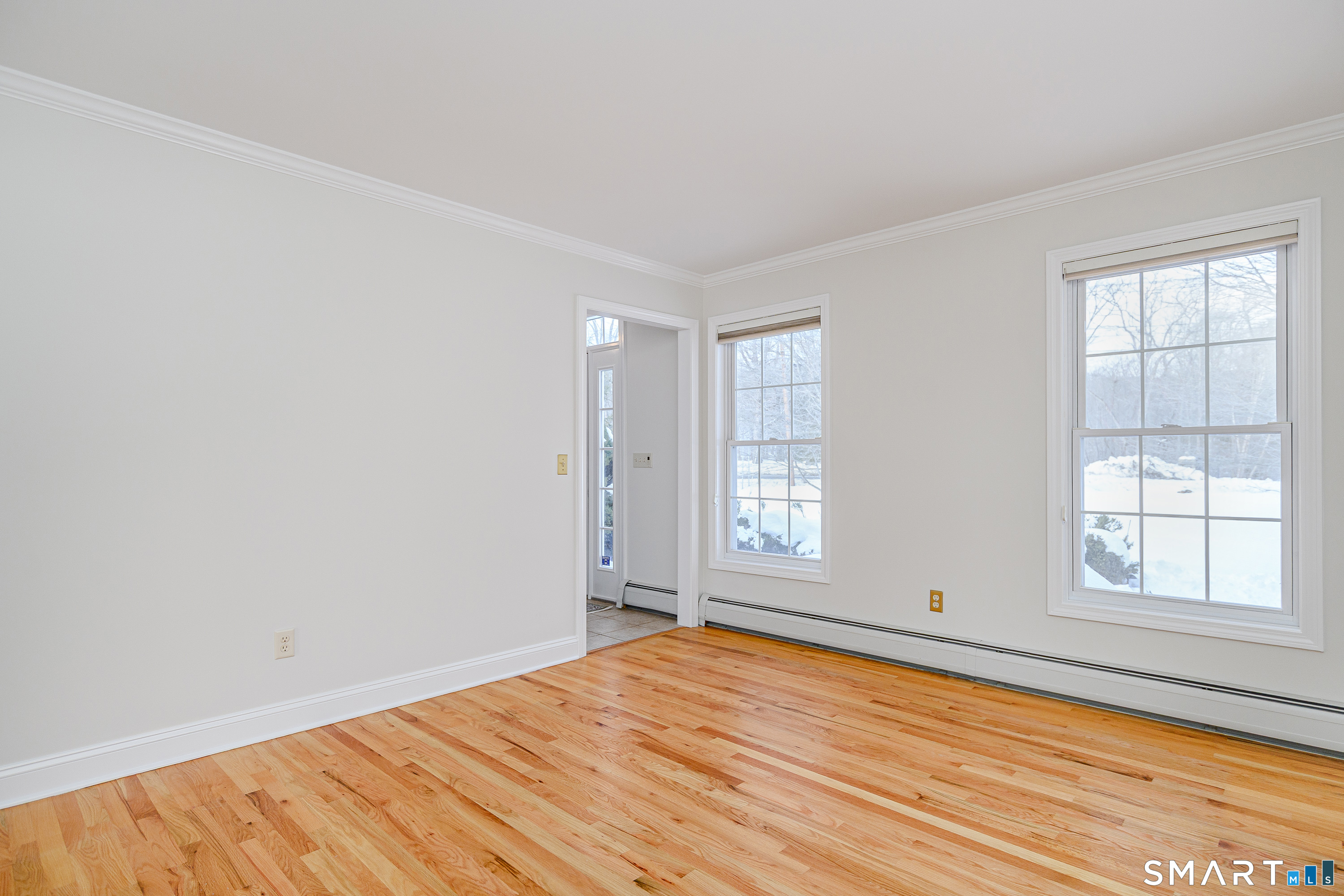 73 Dodgingtown Road Newtown, CT 06470 - Photo 30 of 39 an empty room with wooden floor and windows