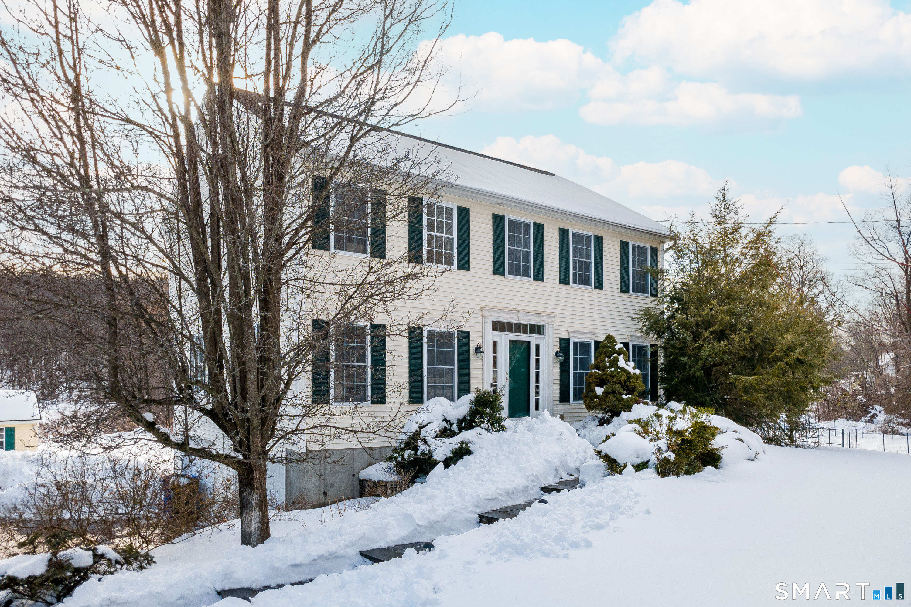73 Dodgingtown Road Newtown, CT 06470 - Photo 34 of 39 a front view of a house with a yard covered in snow
