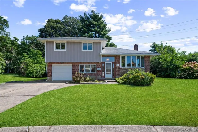 a view of a house with a yard and sitting area