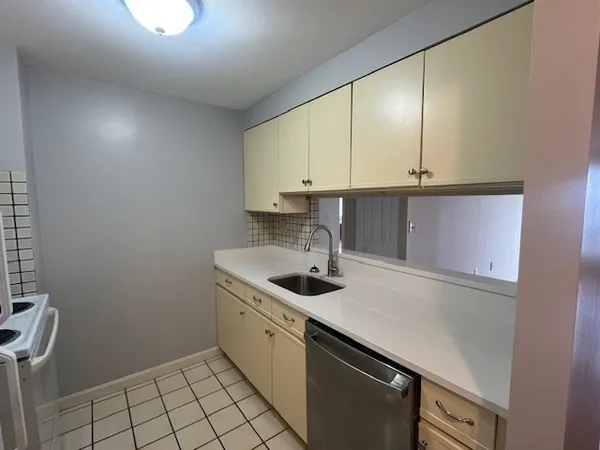 a kitchen with a sink cabinets and window