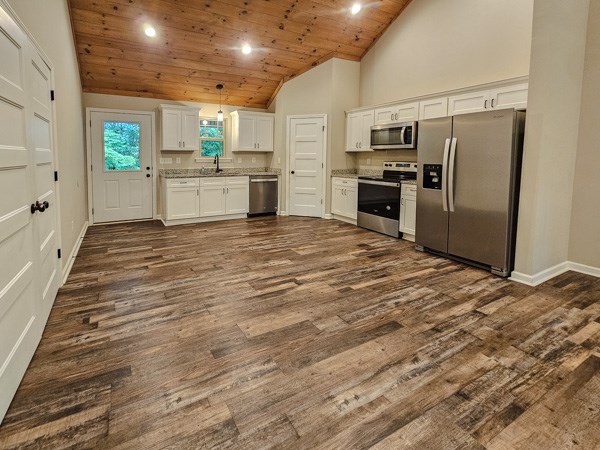 1385 Villa Drive Ellijay, GA 30540 - Photo 14 of 17 a kitchen with stainless steel appliances kitchen island granite countertop a refrigerator and a stove top oven