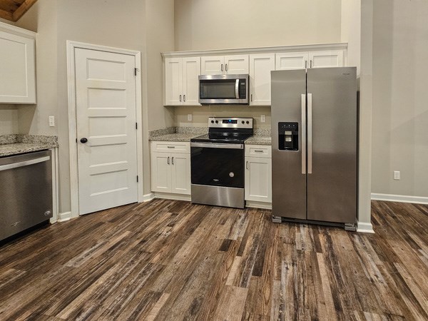 1385 Villa Drive Ellijay, GA 30540 - Photo 15 of 17 a kitchen with a refrigerator stove and white cabinets