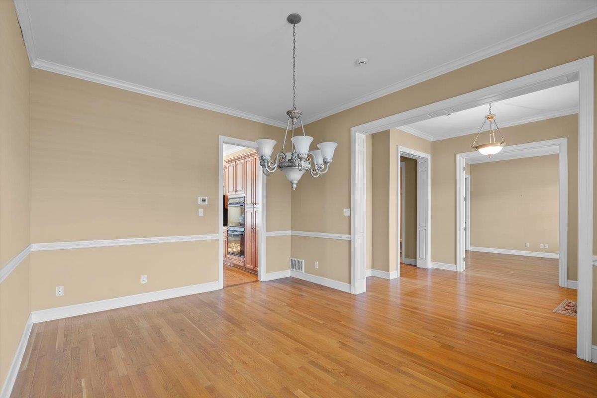 1435 Kimbrough Road Germantown, TN 38138 - Photo 20 of 34 a view of a room with wooden floor and chandelier