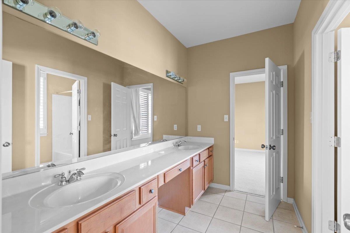 1435 Kimbrough Road Germantown, TN 38138 - Photo 26 of 34 a spacious bathroom with a granite countertop sink a mirror and a