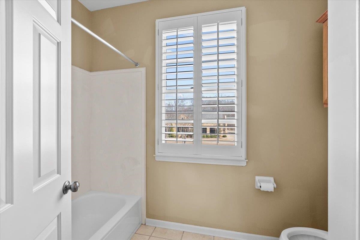 1435 Kimbrough Road Germantown, TN 38138 - Photo 27 of 34 a bathroom with a bathtub and a shower
