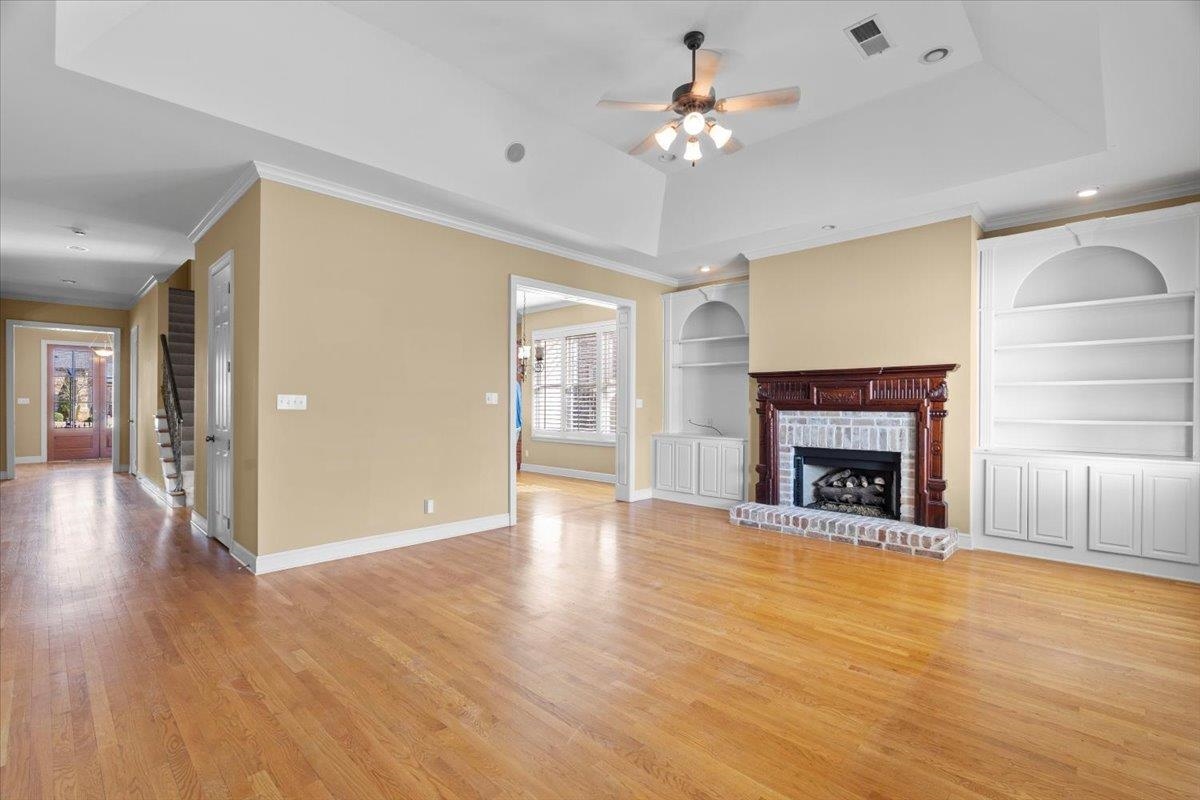 1435 Kimbrough Road Germantown, TN 38138 - Photo 4 of 34 a view of an empty room with wooden floor and a fireplace
