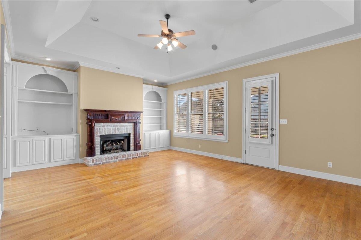 1435 Kimbrough Road Germantown, TN 38138 - Photo 5 of 34 a view of an empty room with a fireplace and a window
