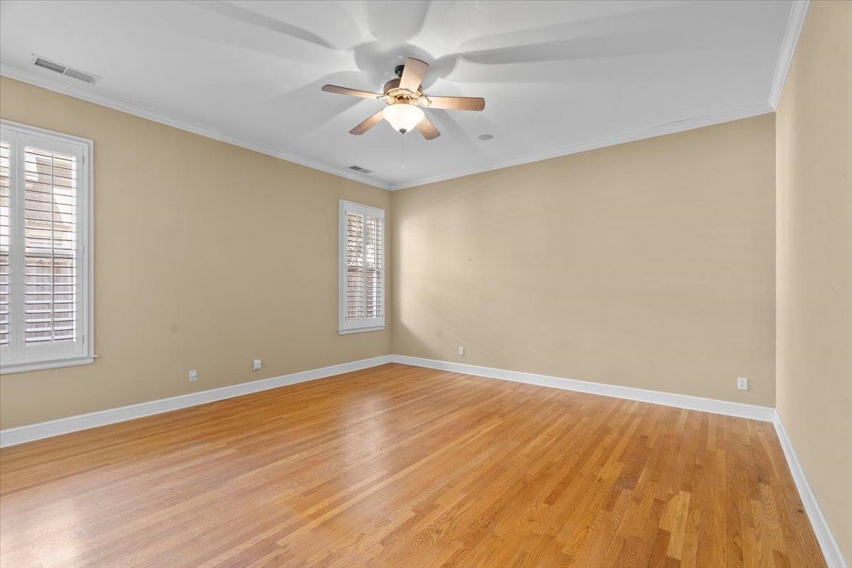 1435 Kimbrough Road Germantown, TN 38138 - Photo 8 of 34 a view of an empty room with wooden floor and a window