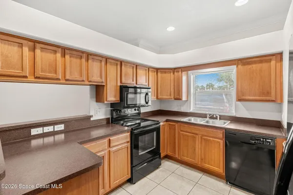a kitchen with stainless steel appliances granite countertop a stove sink and cabinets