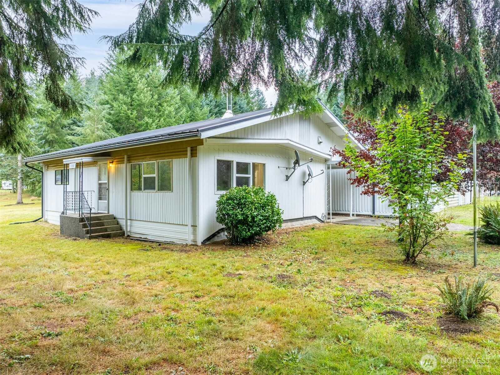 a view of a house with pool and a yard