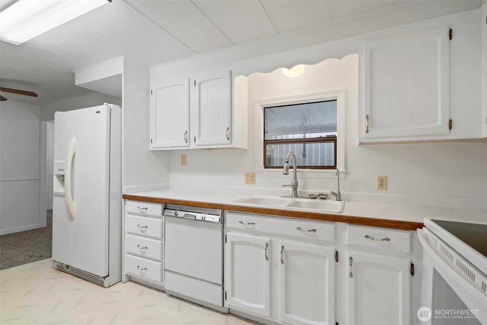 115 Cinebar Road Cinebar, WA 98533 - Photo 4 of 25 a kitchen with white cabinets and white appliances