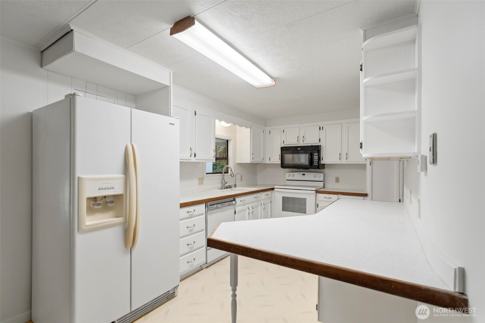 115 Cinebar Road Cinebar, WA 98533 - Photo 5 of 25 a kitchen with white cabinets and stainless steel appliances