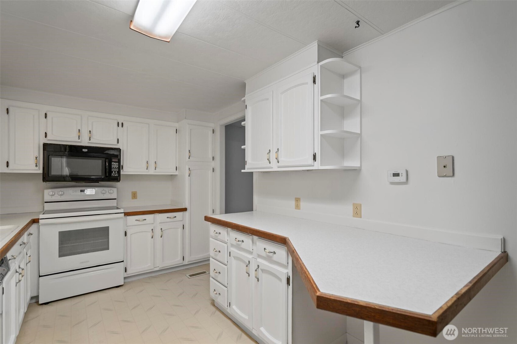 115 Cinebar Road Cinebar, WA 98533 - Photo 6 of 25 a kitchen with white cabinets and white appliances
