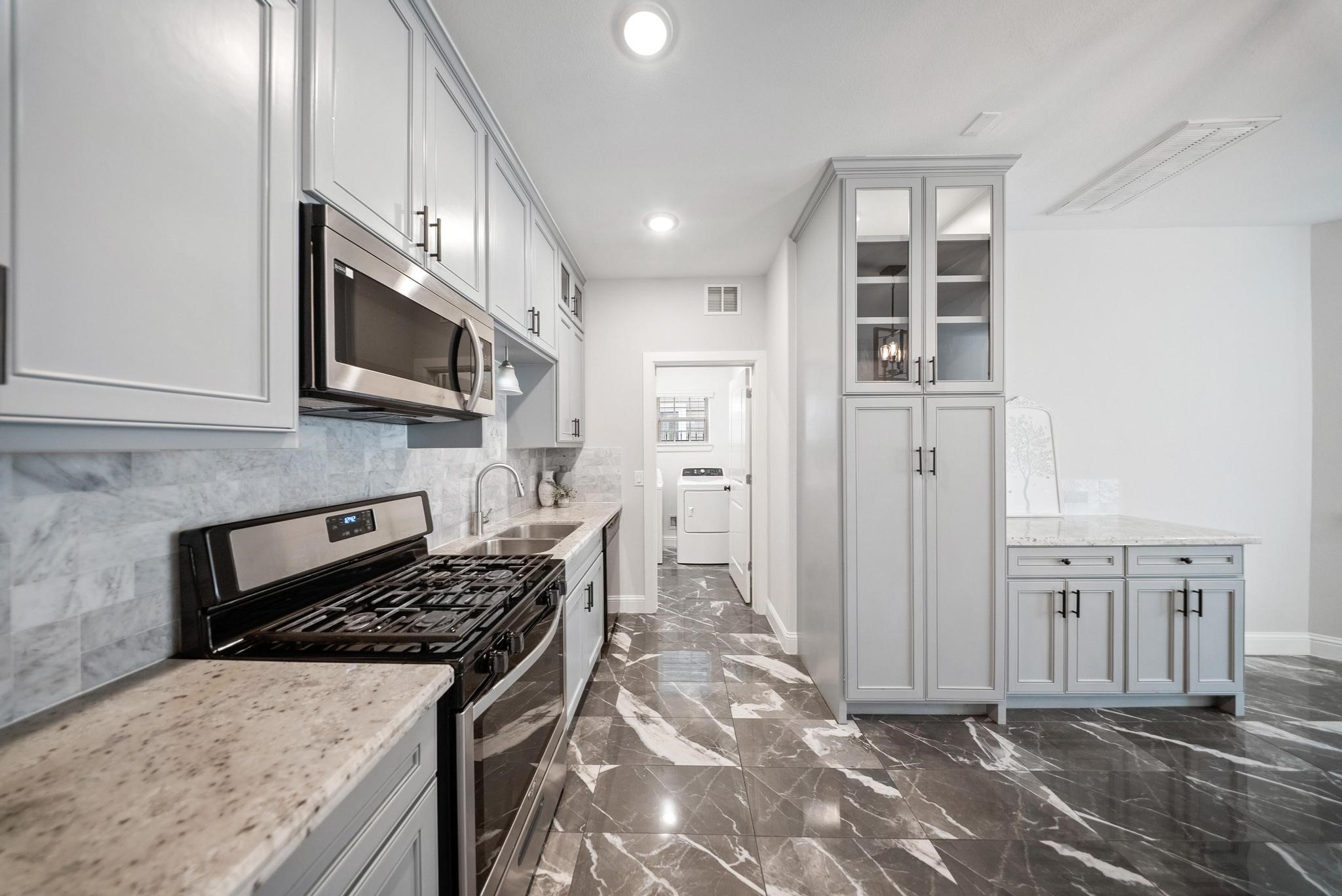 4004 Weslow Street Houston, TX 77087 - Photo 7 of 28 Custom wood cabinets and marble floors