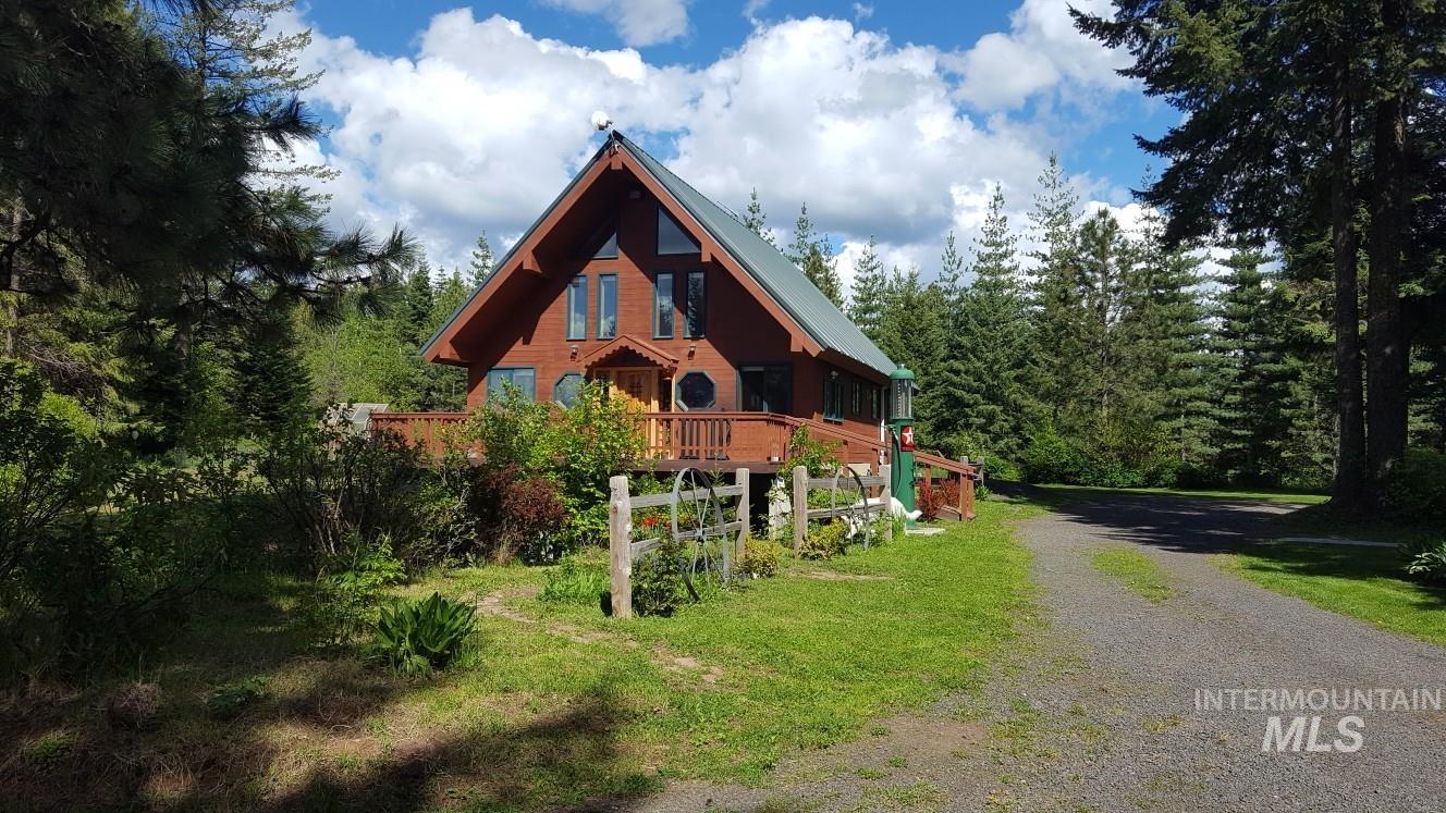 391457 Highway 95 Plummer, ID 83851 - Photo 1 of 39 View of front of house featuring gravel driveway, a view of trees, a metal roof, and a deck