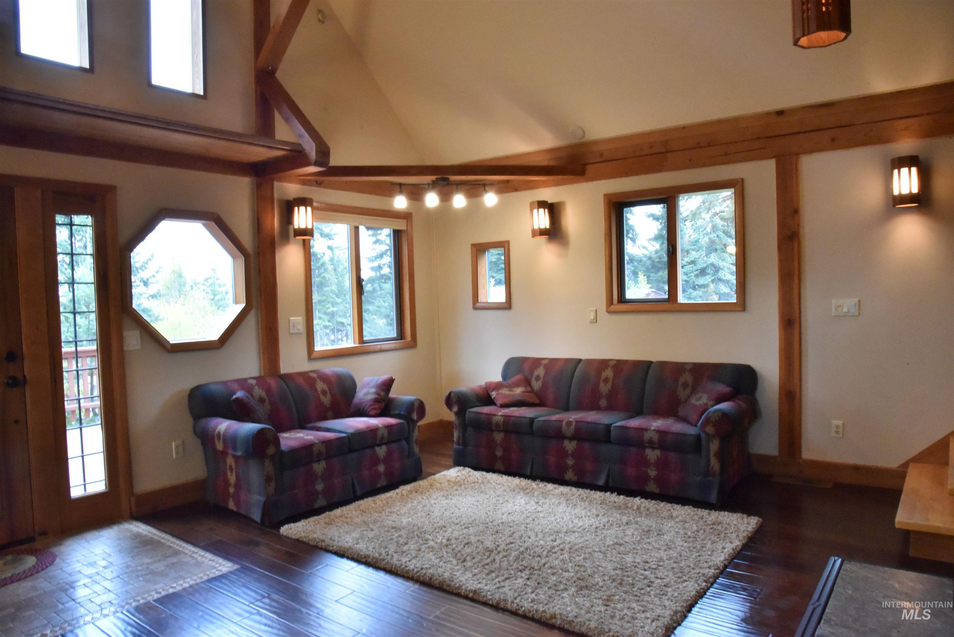 391457 Highway 95 Plummer, ID 83851 - Photo 7 of 39 Living room featuring dark wood-type flooring and high vaulted ceiling