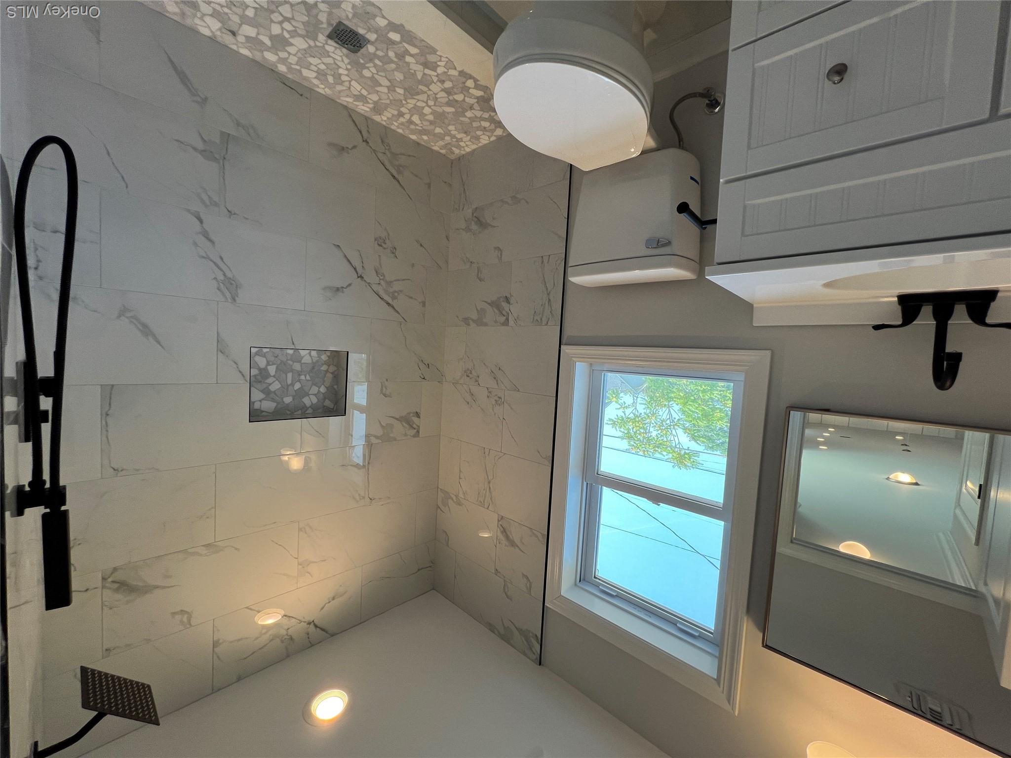 35 Babylon Road Mastic Beach, NY 11951 - Photo 11 of 19 a bathroom with a granite countertop toilet sink and a mirror