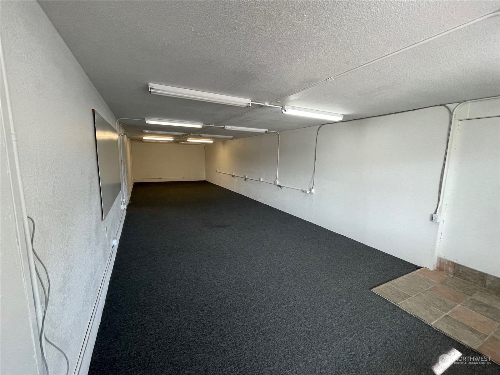 2800 Northeast Lindvog Road Kingston, WA 98346 - Photo 4 of 10 an empty room with wooden floor