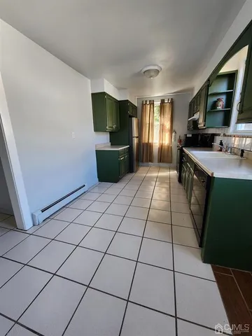 a view of a kitchen with kitchen appliances windows and furniture