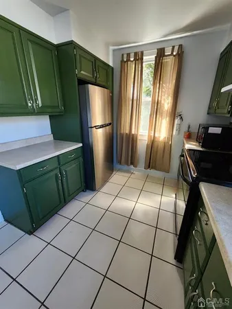 a kitchen with a refrigerator and a stove top oven
