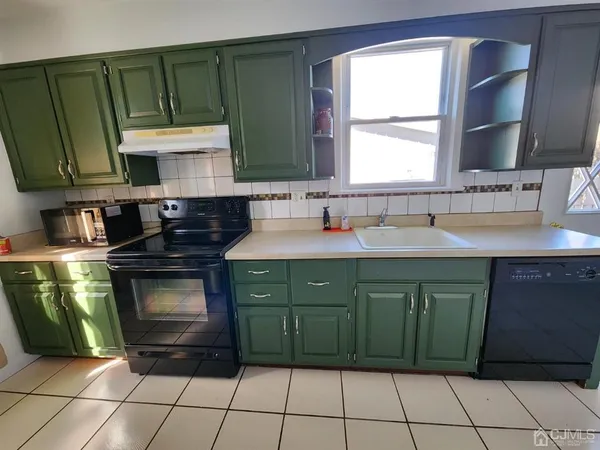 a kitchen with a sink cabinets and washing machine