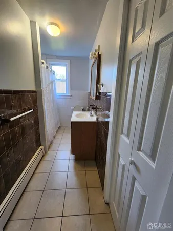 a bathroom with a sink a toilet and mirror