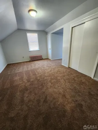 an empty room with a empty space and windows