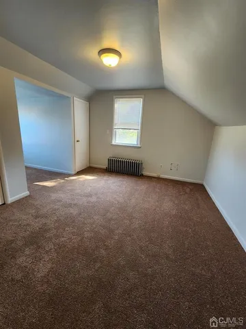 an empty room with a window and closet