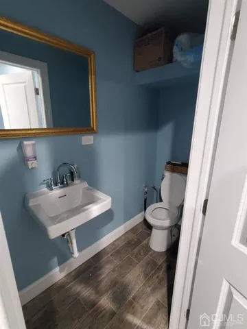 a bathroom with a toilet a sink and a mirror